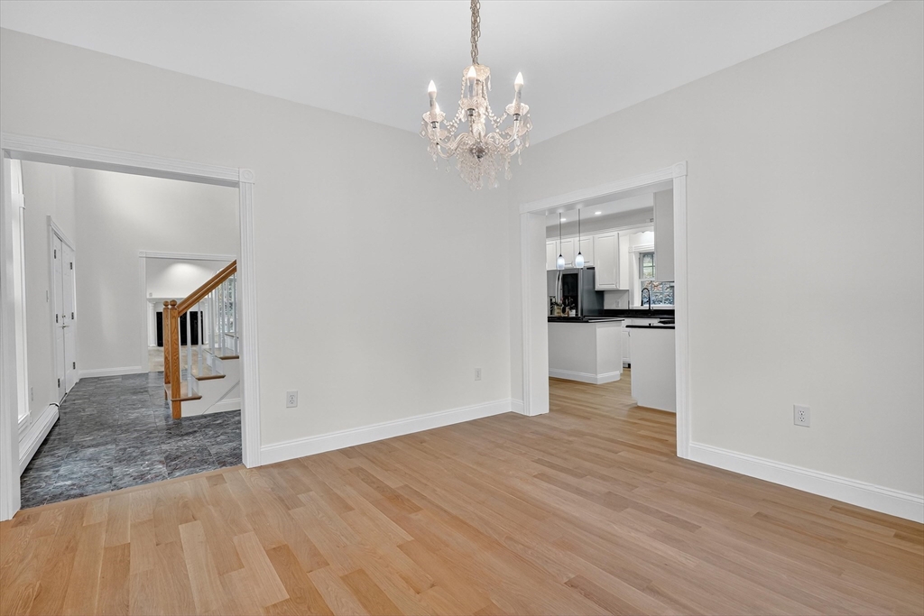 14 Pine Hill Road Framingham, MA 01701 - Photo 20 of 42 a view of a hallway with wooden floor and a kitchen