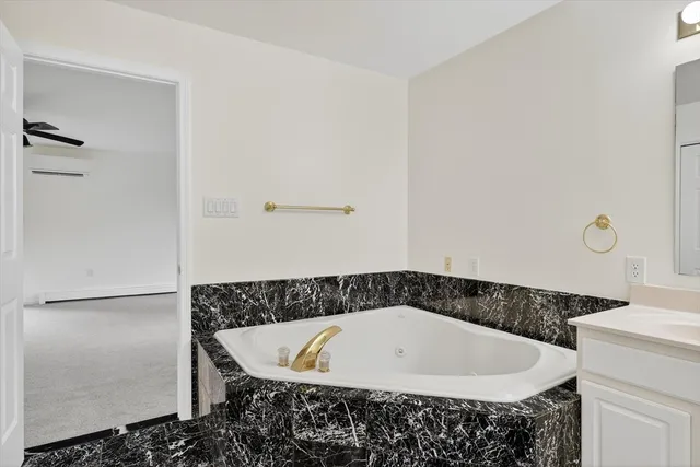 a bathroom with a bathtub and shower