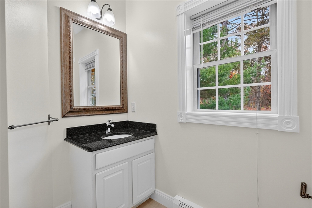 14 Pine Hill Road Framingham, MA 01701 - Photo 30 of 42 a bathroom with a granite countertop sink and a window