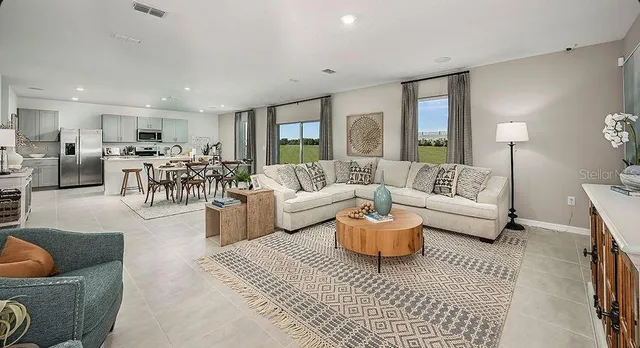 a living room with furniture and a painting on the wall