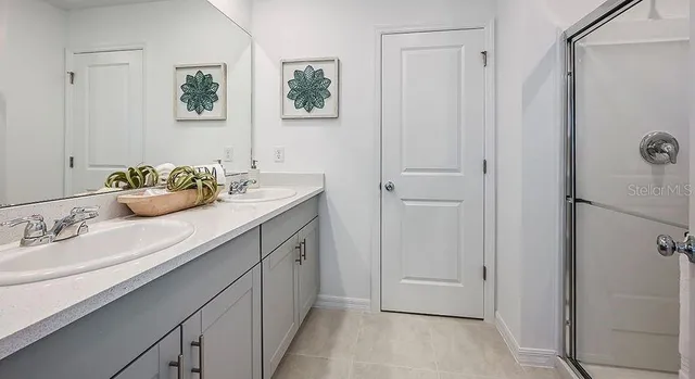 a view of kitchen with refrigerator stove dining table and chairs