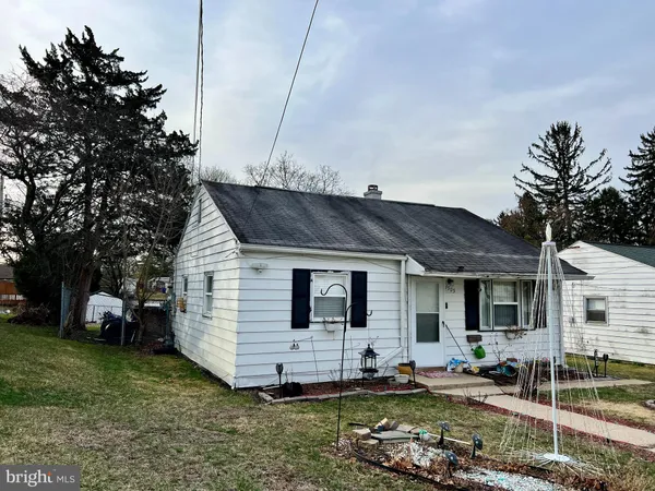 a view of a house with backyard sitting area and garden
