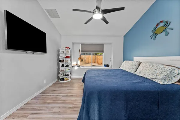 a bathroom with a granite countertop sink a mirror a vanity and shower