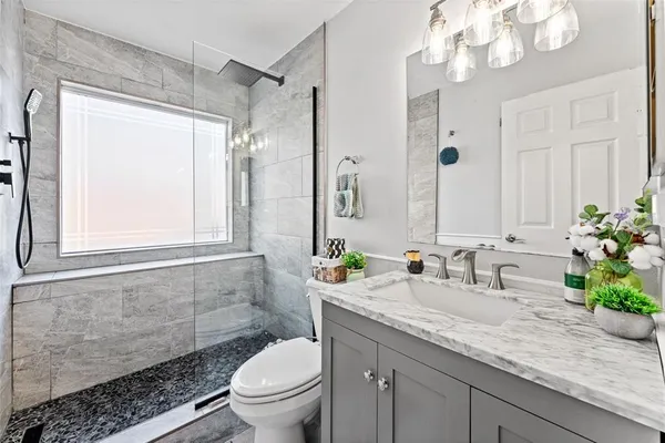 a bedroom with bed and a painting on the wall