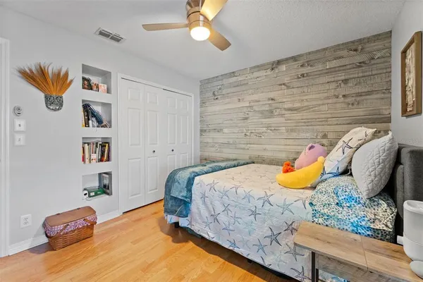 a living room with patio furniture and a floor to ceiling window