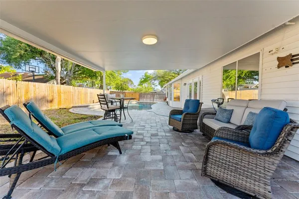 a swimming pool with outdoor seating and yard