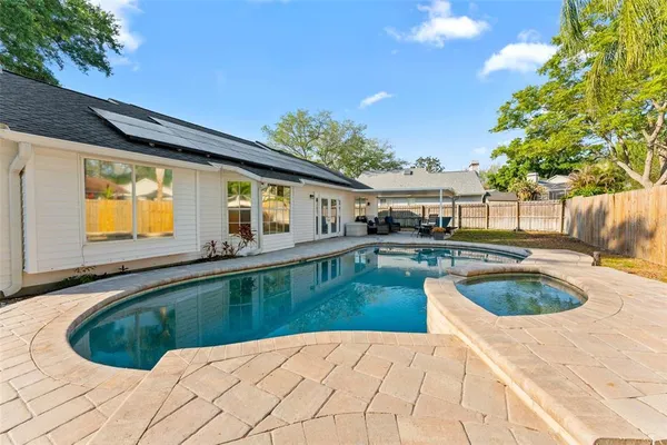 a swimming pool view with a outdoor seating