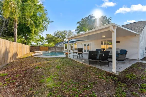 an aerial view of residential houses with outdoor space and trees