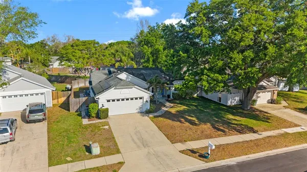 an aerial view of a houses with a yard