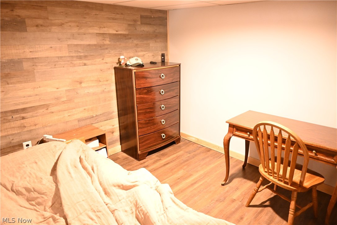94 North 5th Street Rittman, OH 44270 - Photo 17 of 27 bonus room in basement featuring wood panel wall and wood style flooring