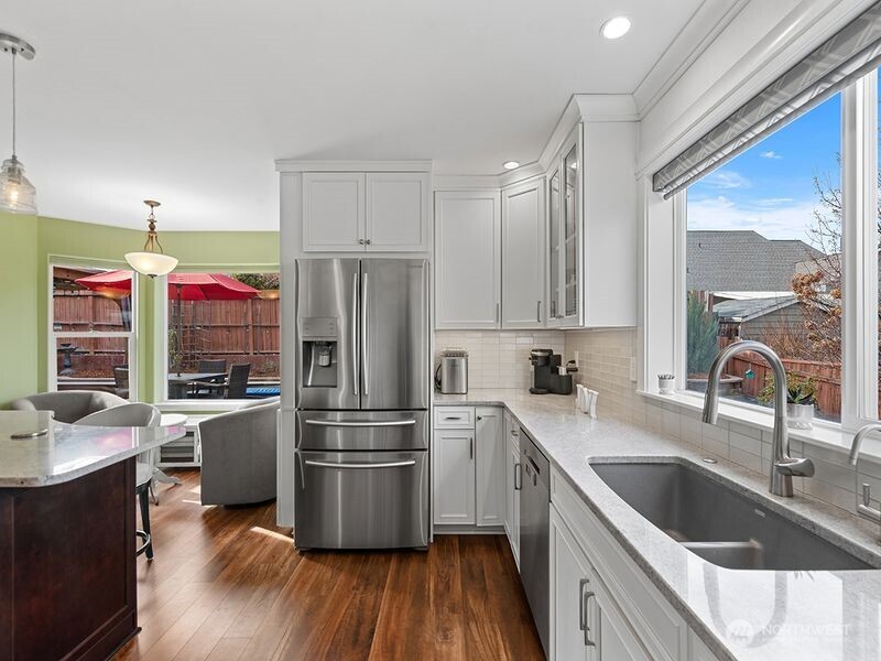 1504 Fuller Street Wenatchee, WA 98801 - Photo 15 of 38 a kitchen with a sink a refrigerator and a stove with wooden floor