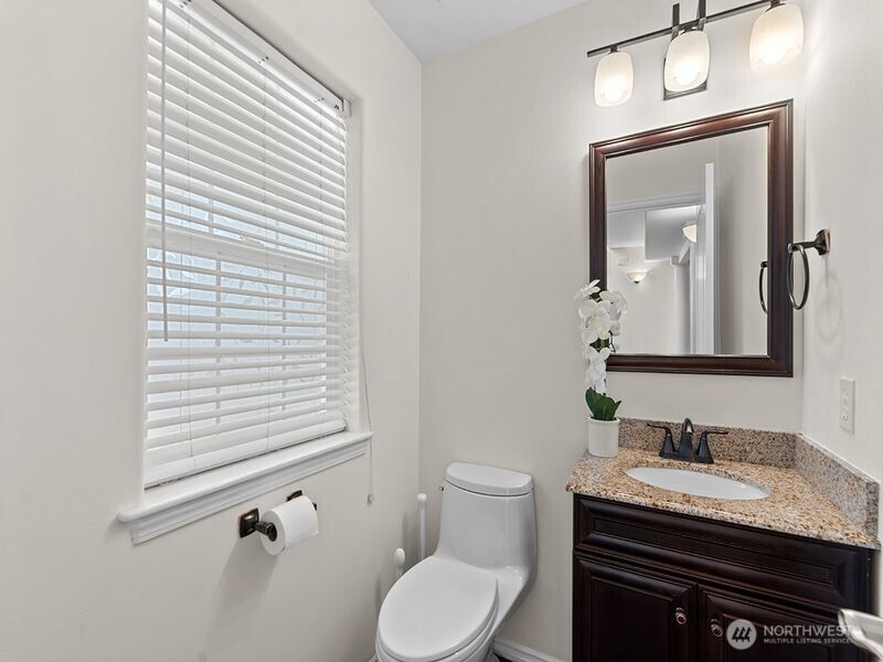 1504 Fuller Street Wenatchee, WA 98801 - Photo 19 of 38 a bathroom with a granite countertop sink vanity mirror and toilet