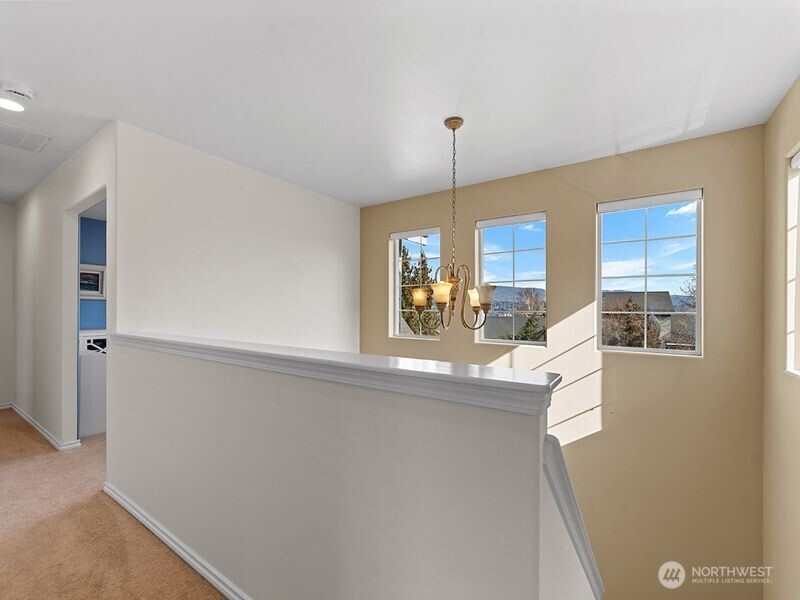1504 Fuller Street Wenatchee, WA 98801 - Photo 21 of 38 a view of a kitchen with kitchen island a window wooden floor and living room