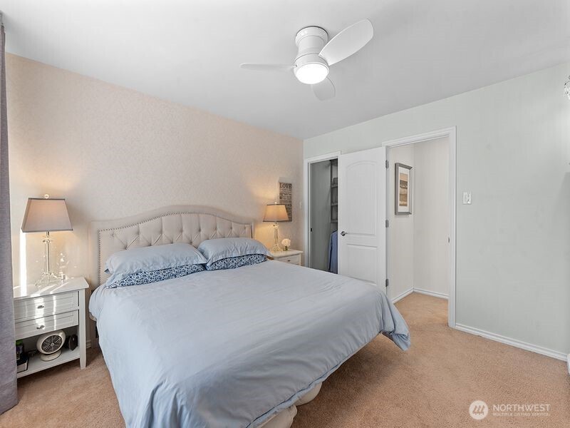 1504 Fuller Street Wenatchee, WA 98801 - Photo 30 of 38 a bedroom with a large bed and a chandelier