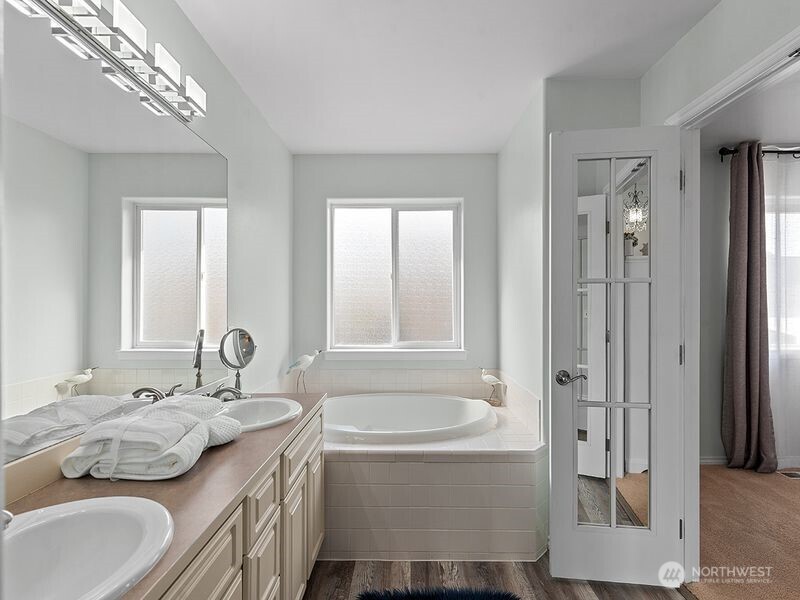 1504 Fuller Street Wenatchee, WA 98801 - Photo 33 of 38 a bathroom with a granite countertop tub sink and mirror