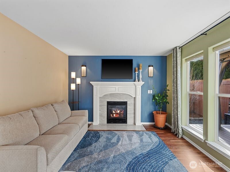 1504 Fuller Street Wenatchee, WA 98801 - Photo 5 of 38 a living room with furniture a flat screen tv and a fireplace