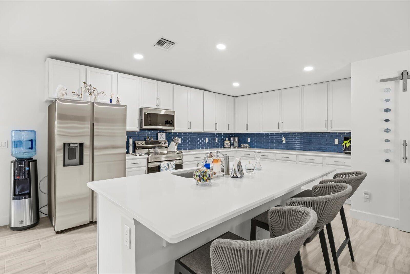 8607 Southwest 7th Lane Okeechobee, FL 34974 - Photo 11 of 44 a kitchen with kitchen island a sink counter and refrigerator