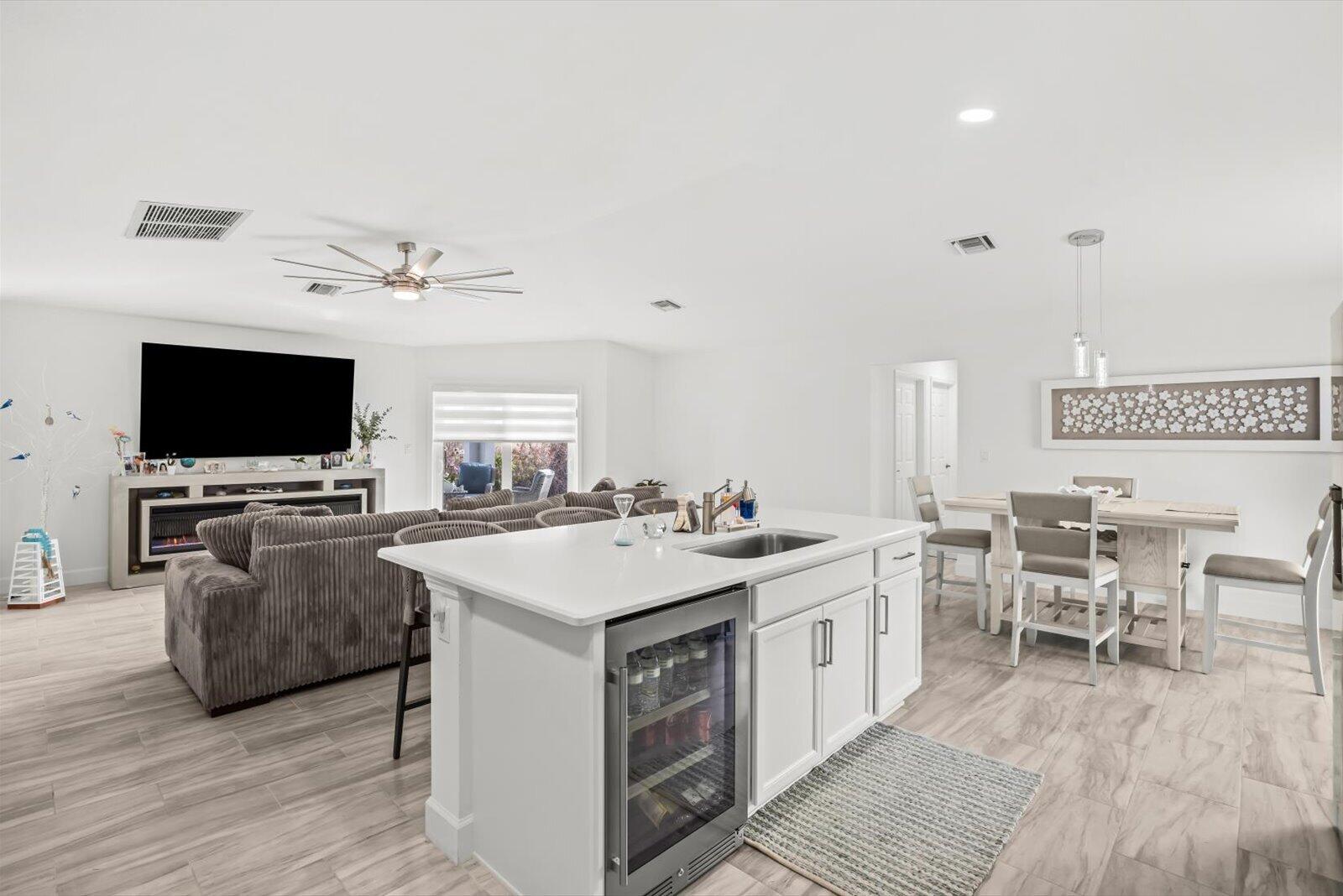 8607 Southwest 7th Lane Okeechobee, FL 34974 - Photo 15 of 44 a view of living room kitchen with stainless steel appliances granite countertop a stove and a flat screen tv