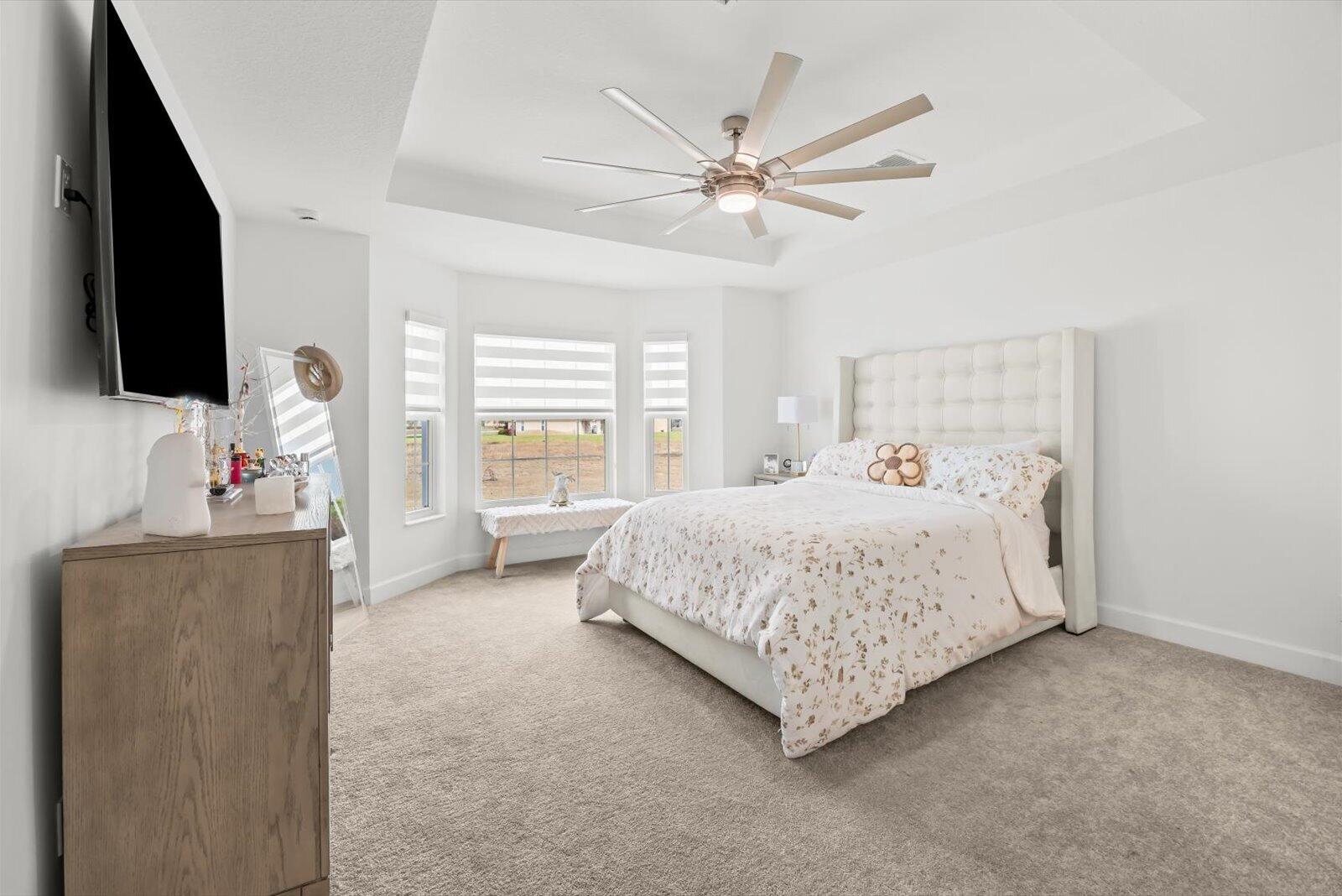 8607 Southwest 7th Lane Okeechobee, FL 34974 - Photo 17 of 44 a spacious bedroom with a bed and a flat screen tv