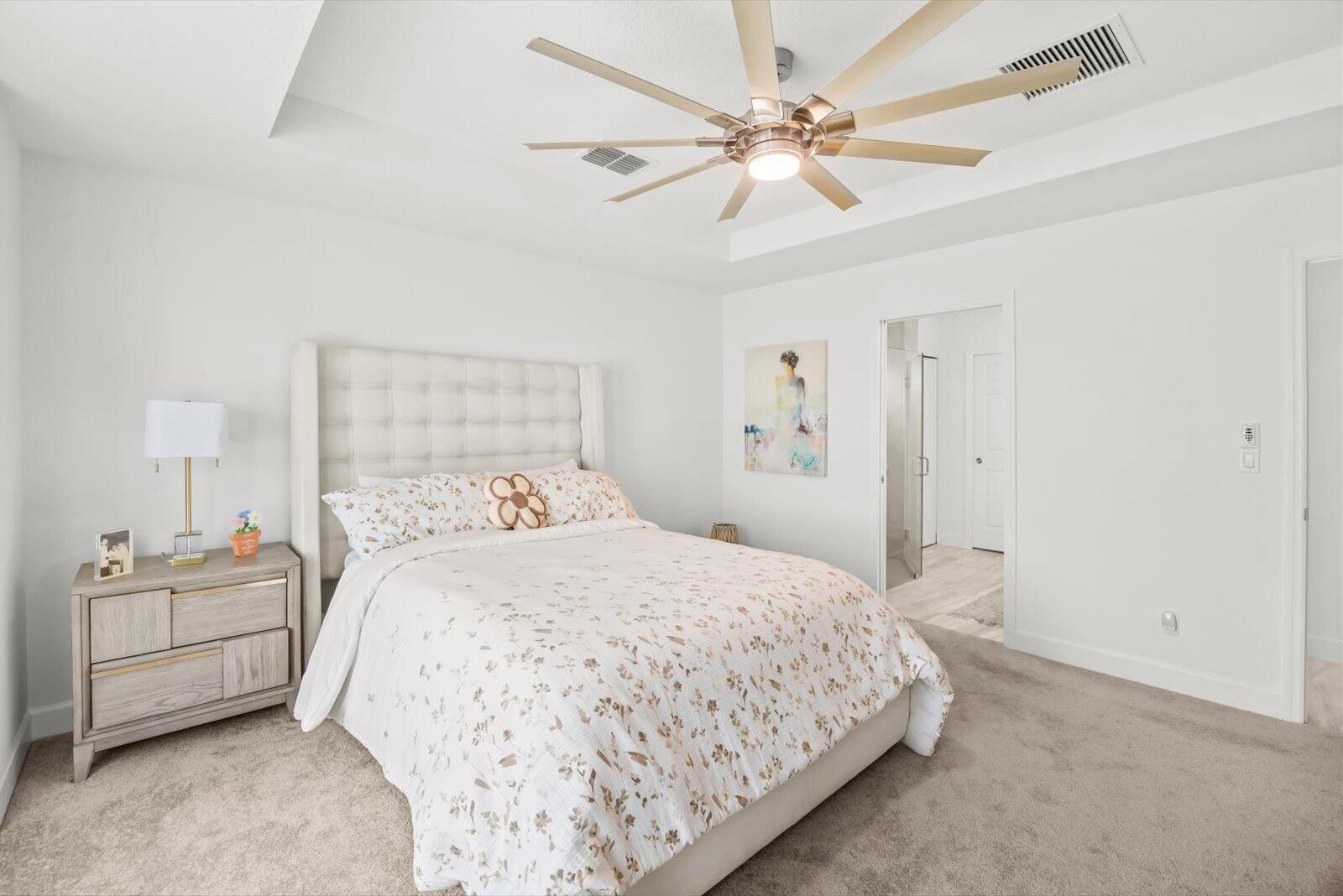 8607 Southwest 7th Lane Okeechobee, FL 34974 - Photo 19 of 44 a bedroom with a bed and a chandelier