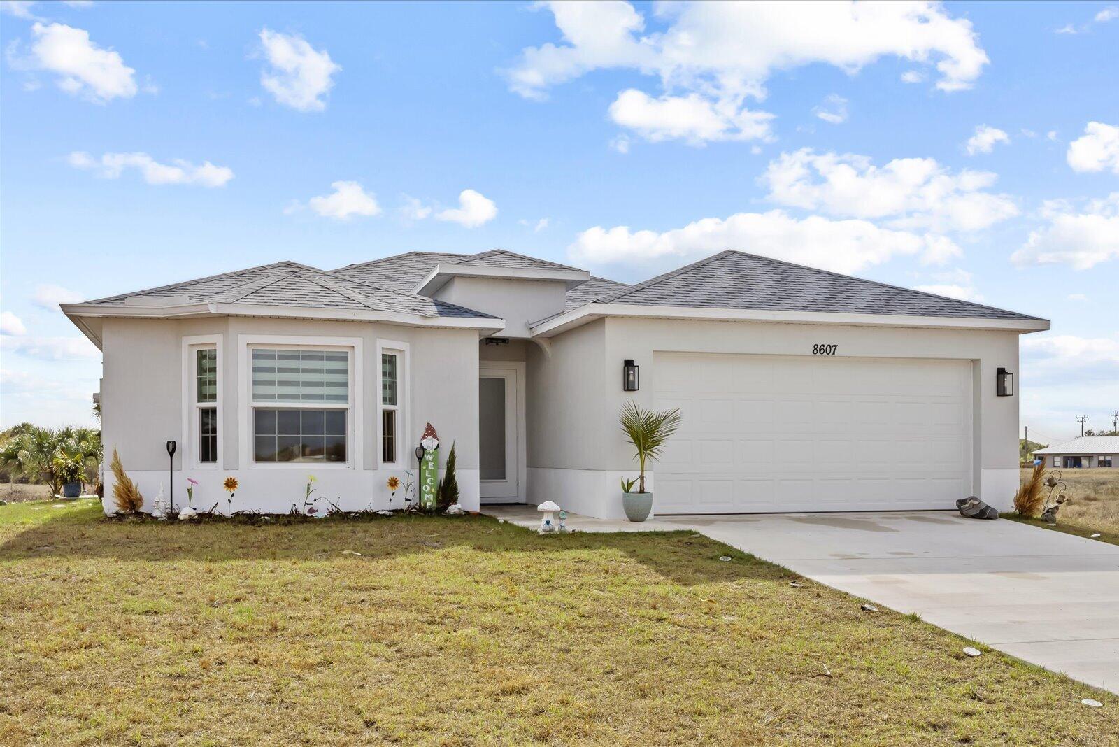 8607 Southwest 7th Lane Okeechobee, FL 34974 - Photo 2 of 44 a view of a house with backyard and garden