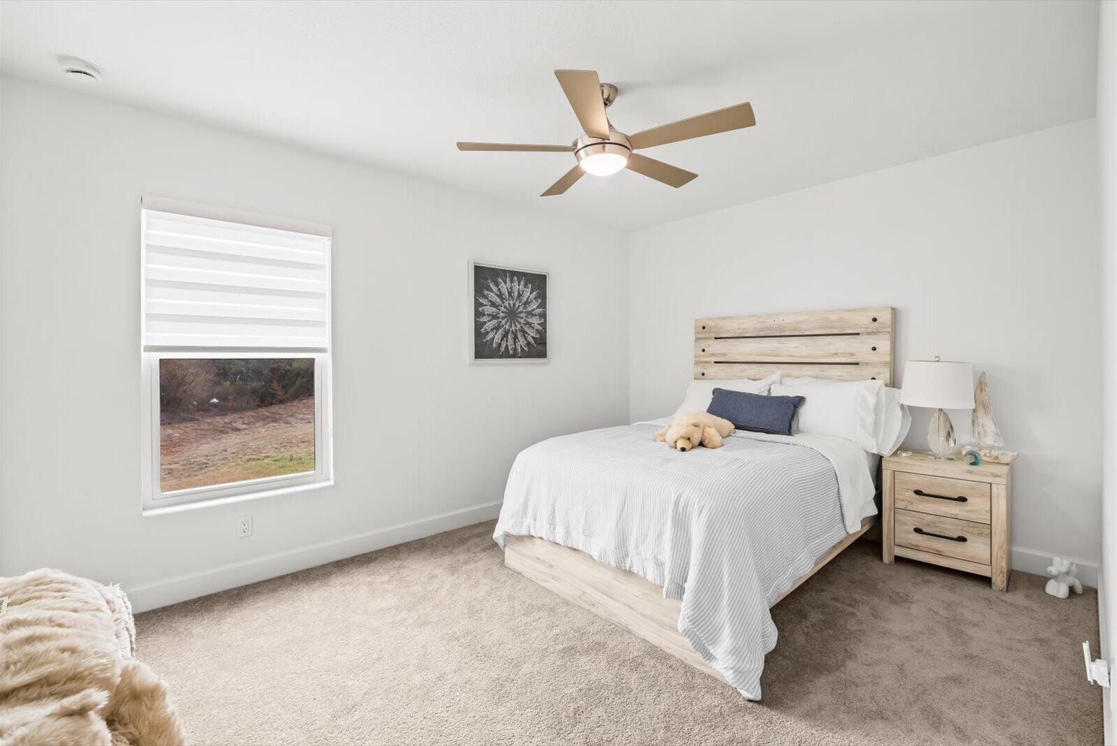 8607 Southwest 7th Lane Okeechobee, FL 34974 - Photo 24 of 44 a bedroom with a bed and a window
