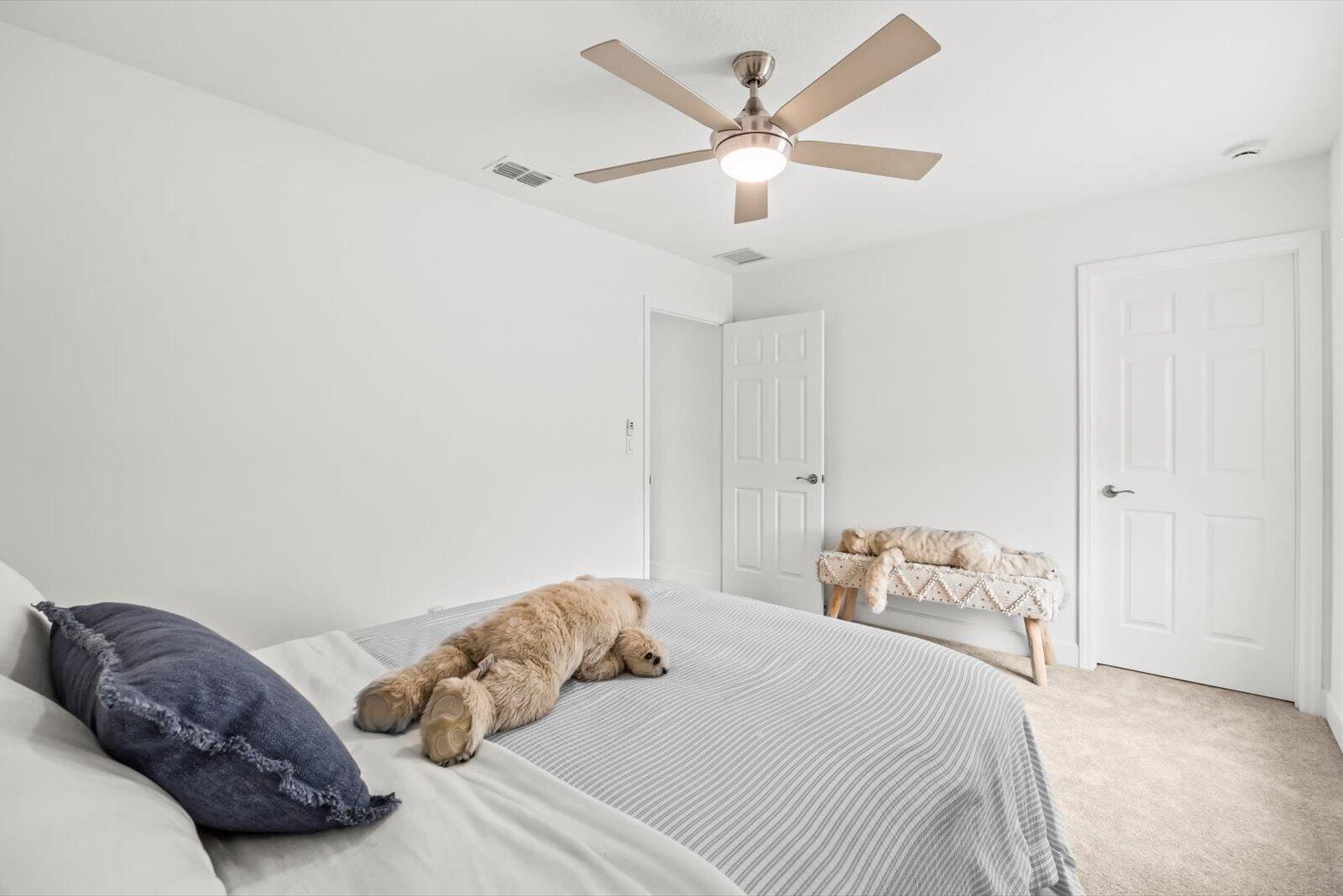 8607 Southwest 7th Lane Okeechobee, FL 34974 - Photo 25 of 44 a bedroom with a bed and a chandelier