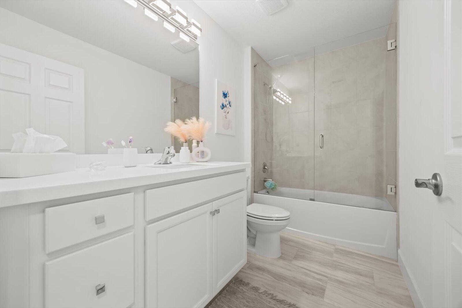 8607 Southwest 7th Lane Okeechobee, FL 34974 - Photo 26 of 44 a bathroom with a sink a toilet and shower