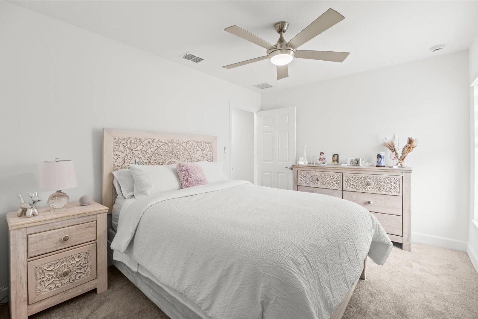 8607 Southwest 7th Lane Okeechobee, FL 34974 - Photo 29 of 44 a bedroom with a bed and a chandelier