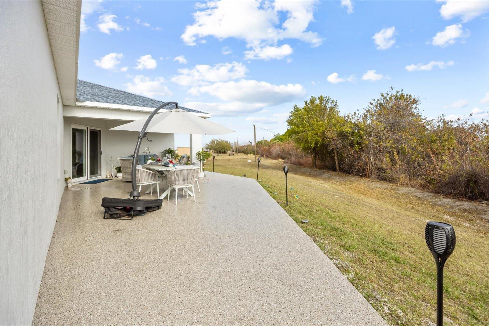8607 Southwest 7th Lane Okeechobee, FL 34974 - Photo 35 of 44 a swimming pool with outdoor seating and yard in the back