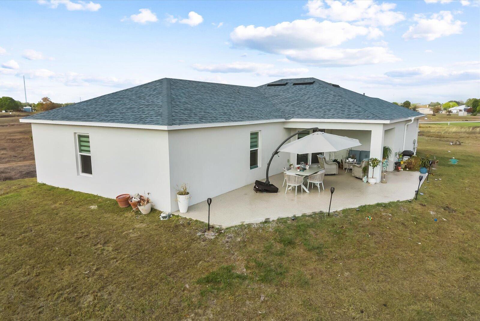 8607 Southwest 7th Lane Okeechobee, FL 34974 - Photo 36 of 44 a view of a patio with table and chairs under an umbrella