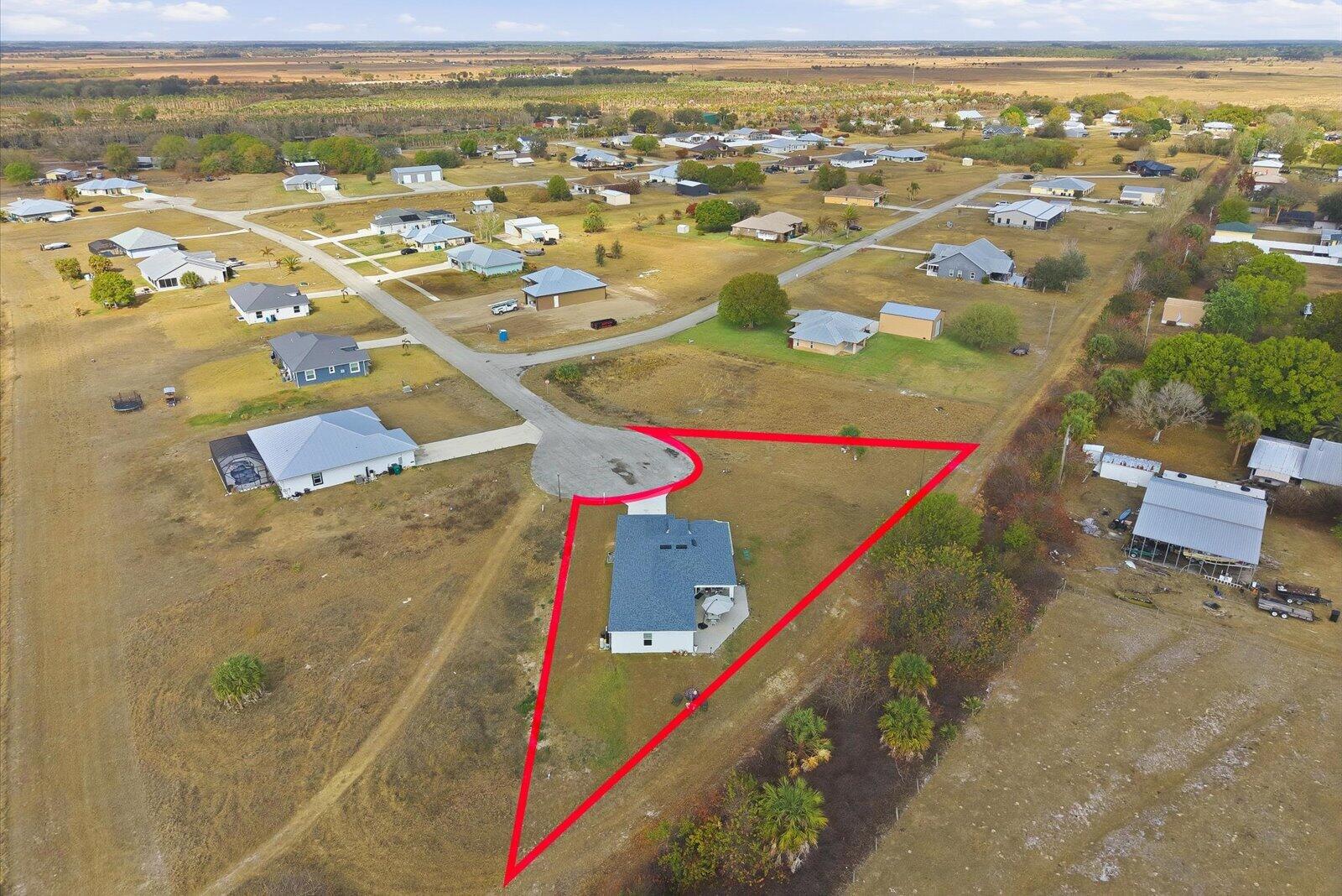 8607 Southwest 7th Lane Okeechobee, FL 34974 - Photo 41 of 44 an aerial view of residential houses with outdoor space