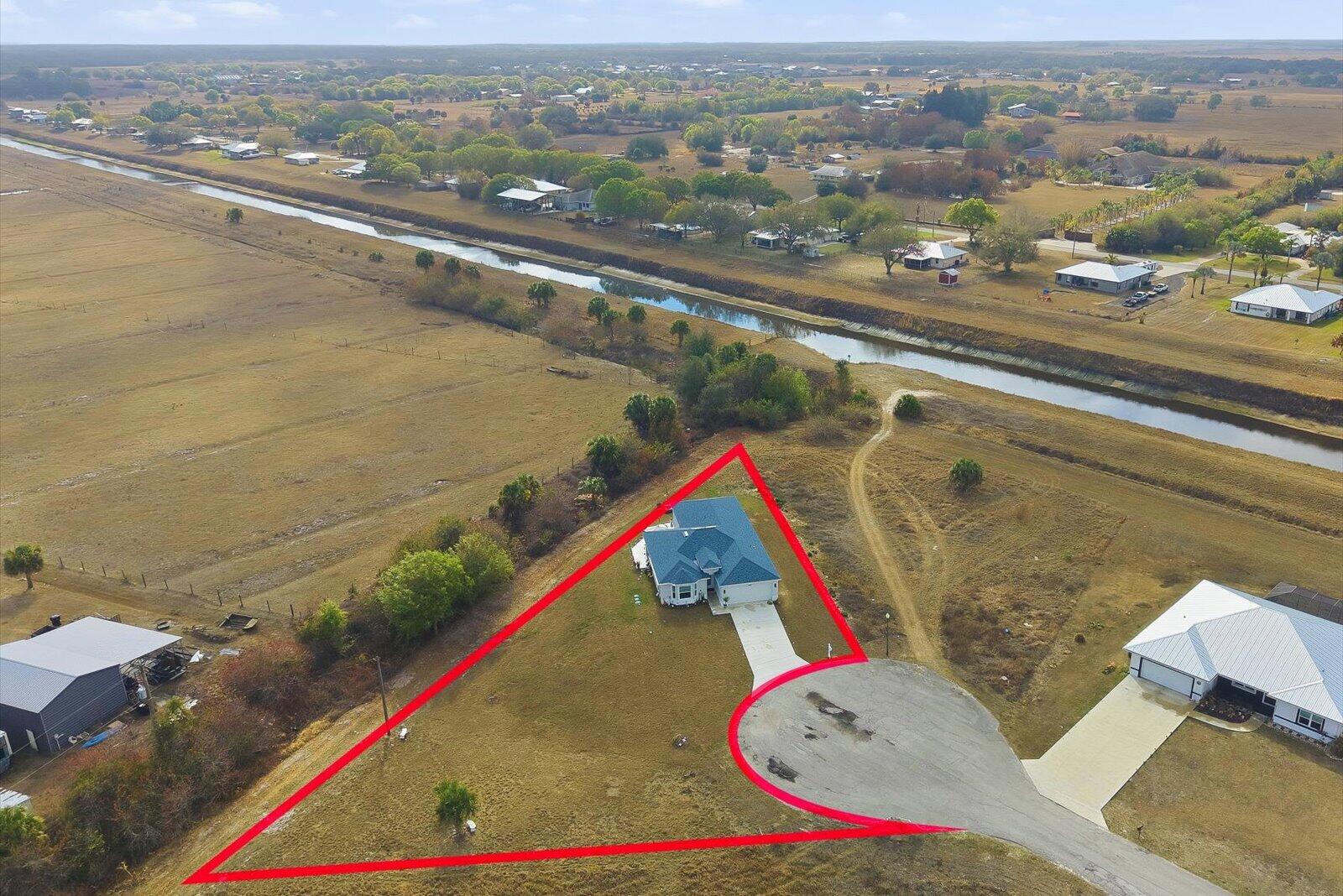 8607 Southwest 7th Lane Okeechobee, FL 34974 - Photo 43 of 44 an aerial view of residential houses with outdoor space