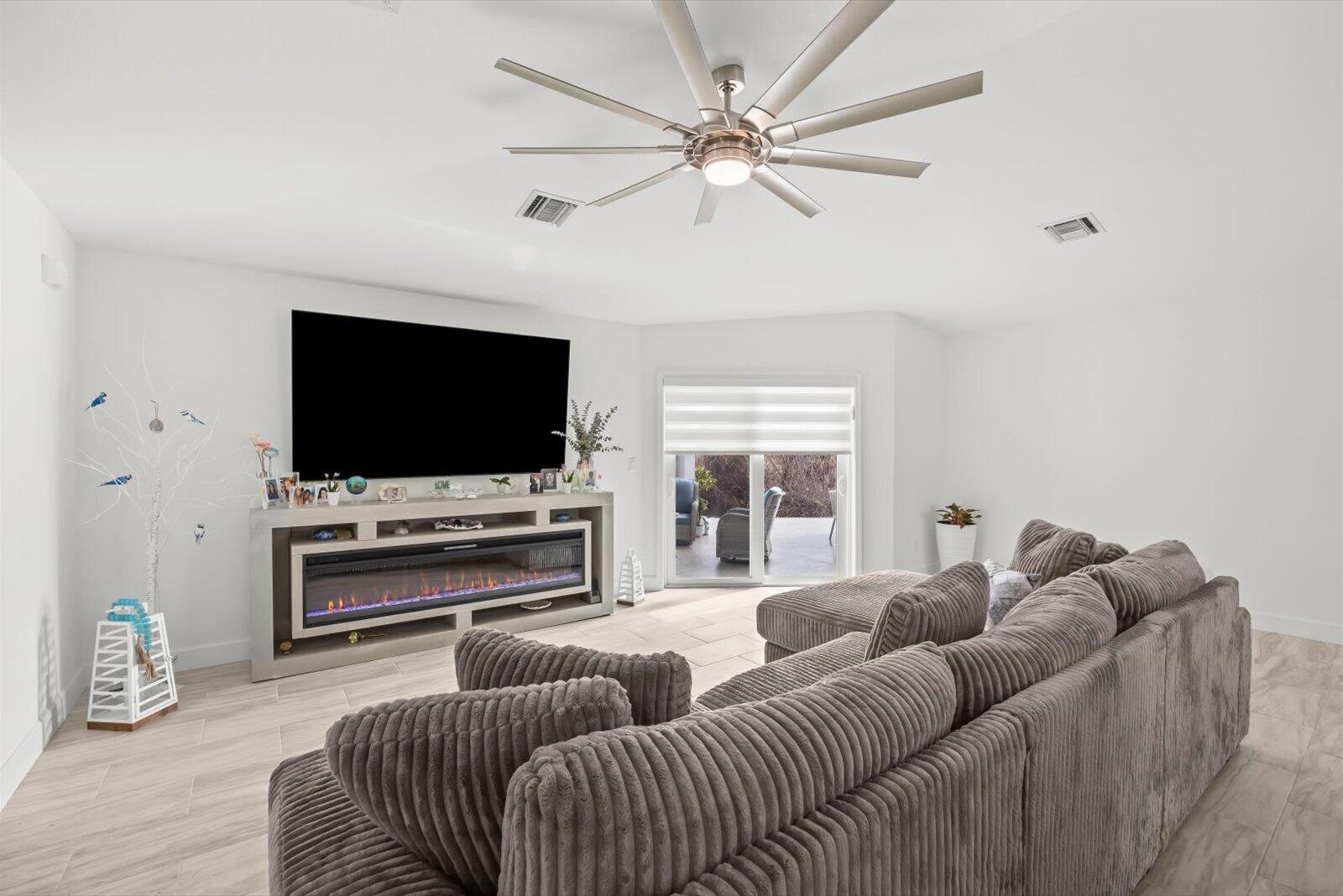 8607 Southwest 7th Lane Okeechobee, FL 34974 - Photo 7 of 44 a living room with furniture and a flat screen tv