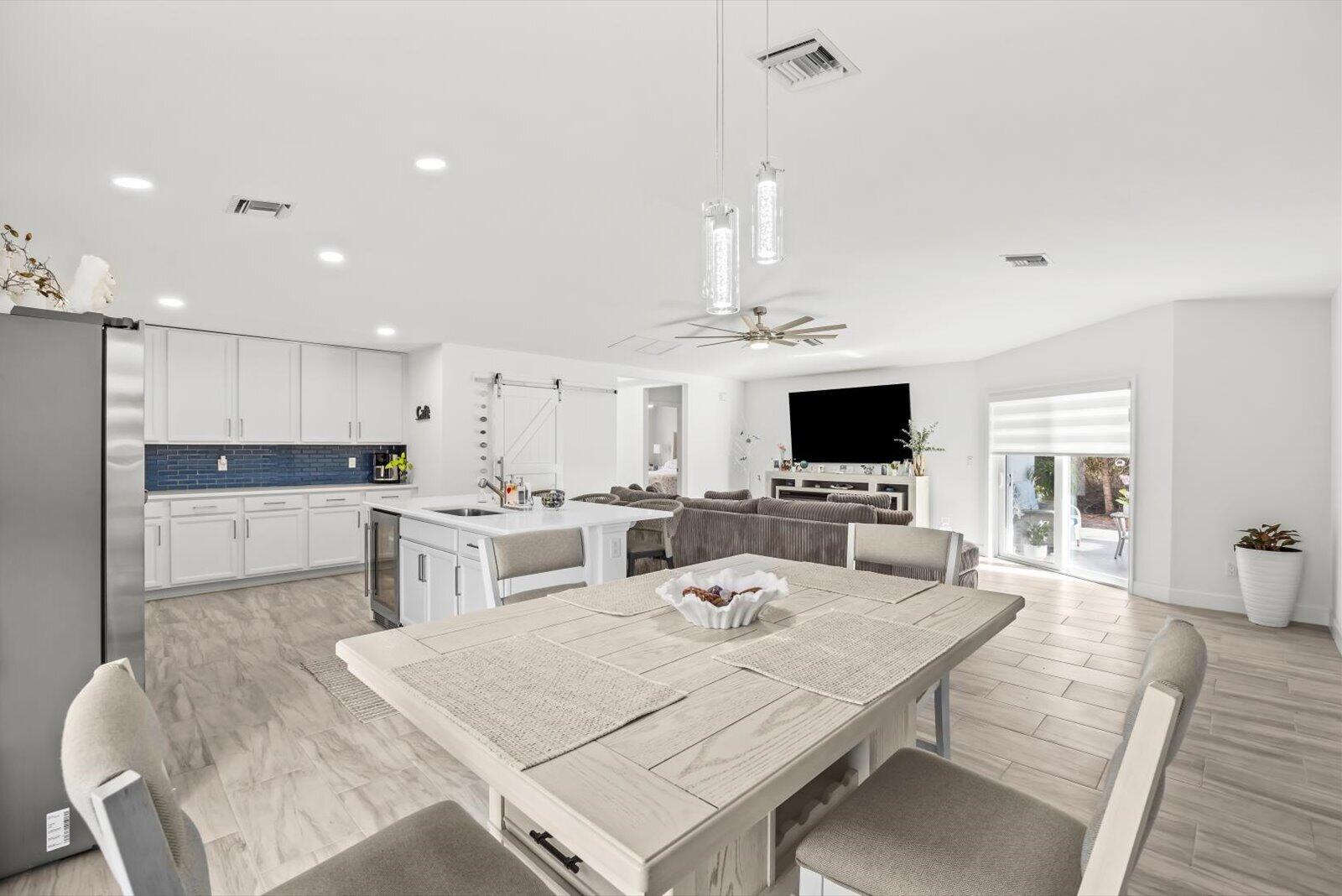 8607 Southwest 7th Lane Okeechobee, FL 34974 - Photo 10 of 44 a living room with stainless steel appliances furniture a flat screen tv and a view of kitchen