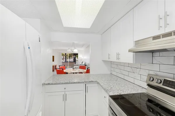 a kitchen with a stove and a cabinets
