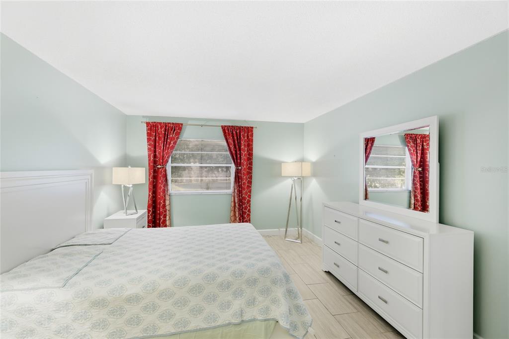 2300 Stickney Point Road, Unit 102 Sarasota, FL 34231 - Photo 13 of 32 a bedroom with a bed and a window