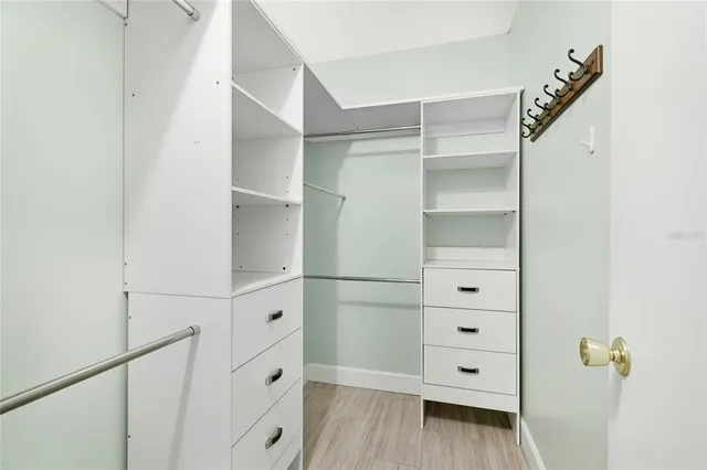 a view of walk in closet with empty racks