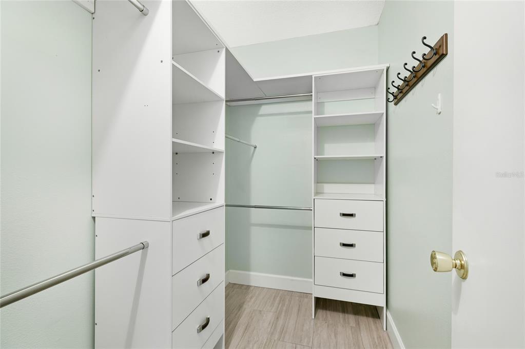 2300 Stickney Point Road, Unit 102 Sarasota, FL 34231 - Photo 15 of 32 a view of walk in closet with empty racks