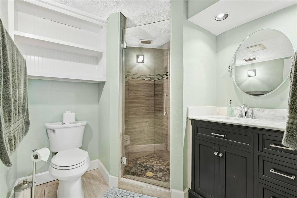 2300 Stickney Point Road, Unit 102 Sarasota, FL 34231 - Photo 16 of 32 a bathroom with a toilet a sink and mirror