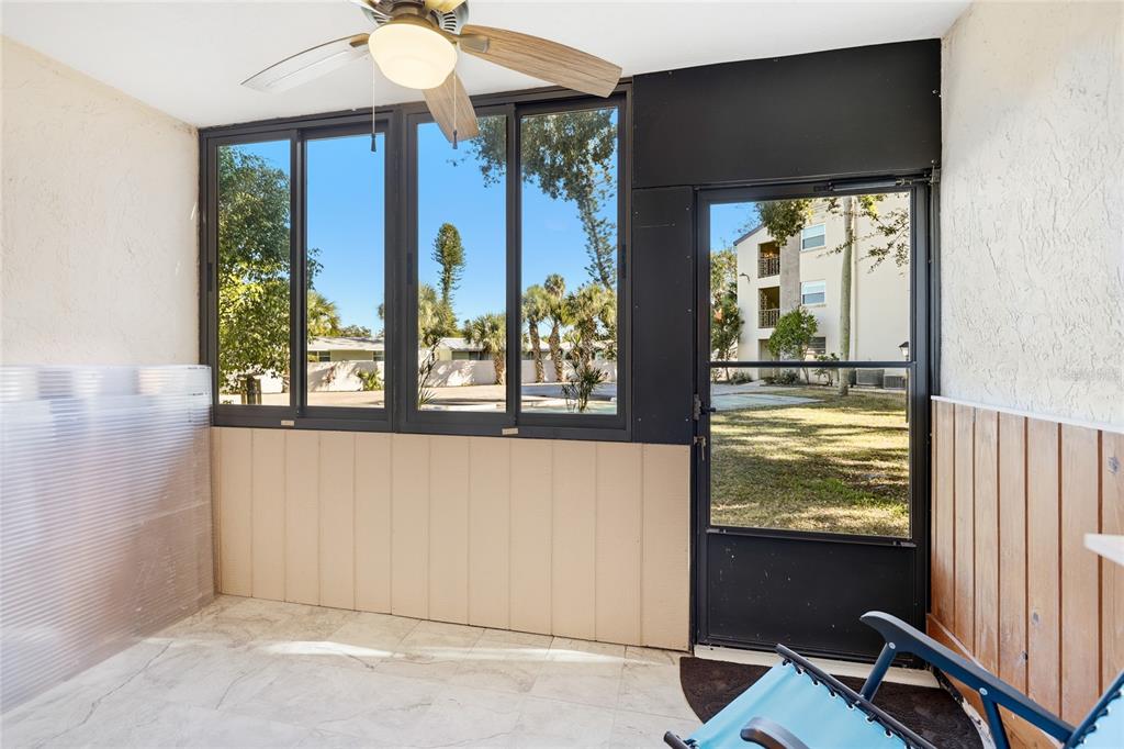 2300 Stickney Point Road, Unit 102 Sarasota, FL 34231 - Photo 20 of 32 a view of a livingroom with wooden floor and a window