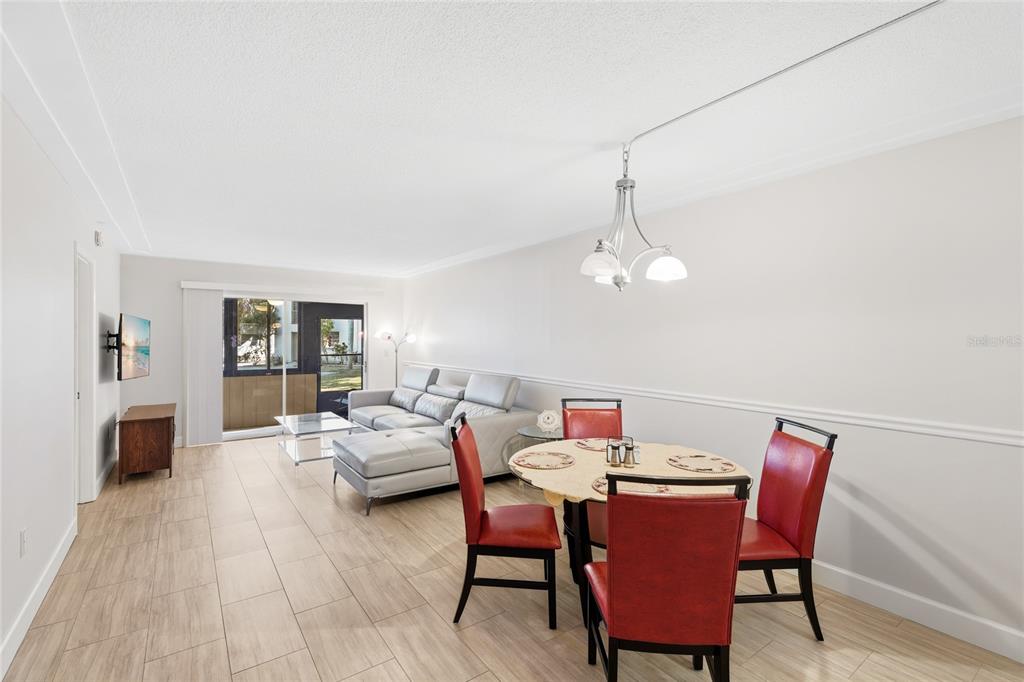 2300 Stickney Point Road, Unit 102 Sarasota, FL 34231 - Photo 2 of 32 a dining room with furniture and window