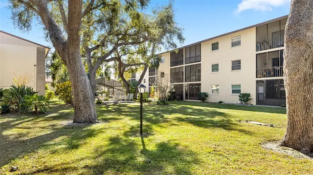 a view of a house with swimming pool and sitting area