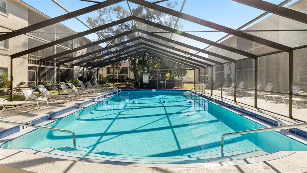 2300 Stickney Point Road, Unit 102 Sarasota, FL 34231 - Photo 28 of 32 a view of a swimming pool with a patio