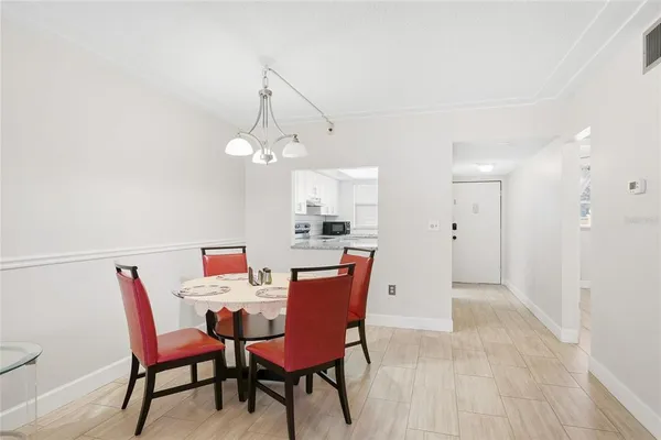 a dining room with furniture and window