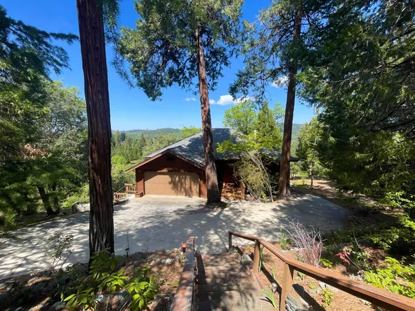 a view of a yard with wooden fence