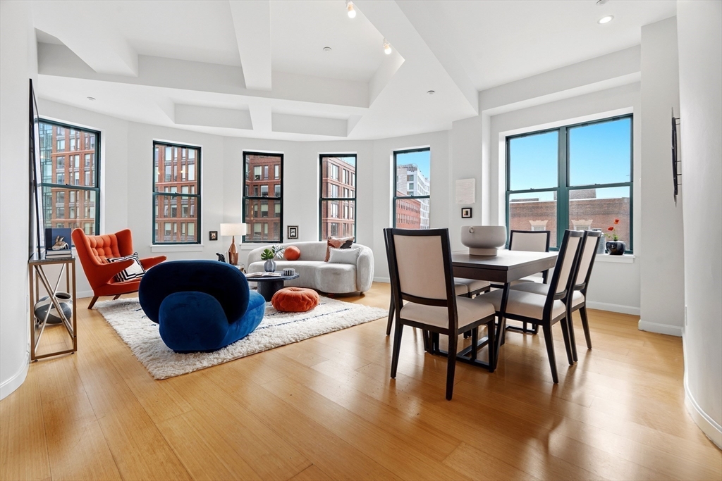 40 Fay Street, Unit 406 Boston, MA 02118 - Photo 1 of 19 a view of a dining room with furniture and wooden floor