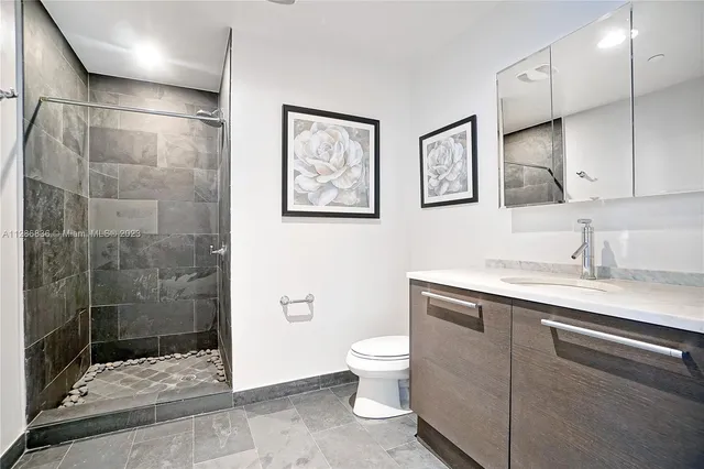 a bathroom with a toilet sink and shower