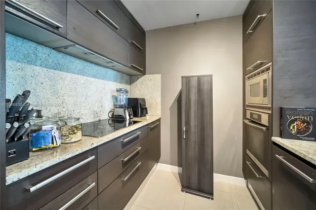 a kitchen with stainless steel appliances a refrigerator and a stove