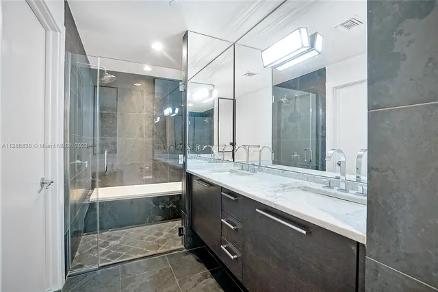 a bathroom with a granite countertop sink mirror and double